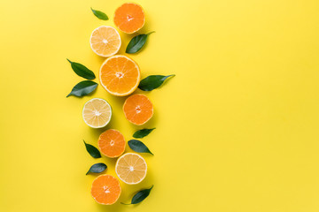Creative background with tropical fruits. Orange, lemon, lime, grapefruit on a yellow background. Flat lay top view copy space. Nutrition Concept, Vitamin C, Disease Prevention, Flu