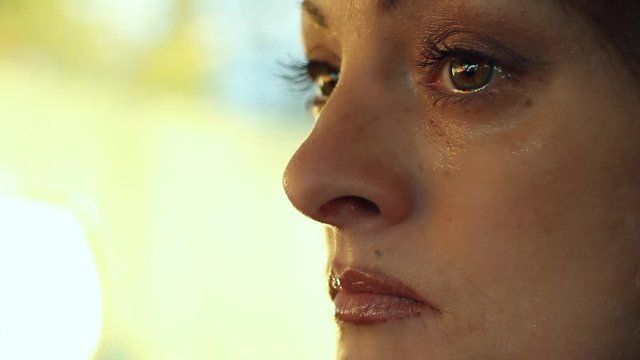 Sad reflective closeup of a young woman's face full of sadness and despair.