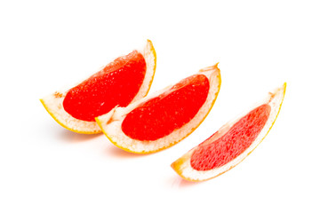Fototapeta na wymiar Orange-red grapefruit in a cut on a white background. close up
