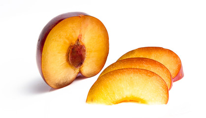 Ripe red plum in a cut on a white background. close up