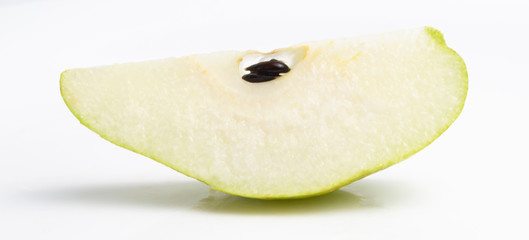 Green pear in a cut on a white background. close up