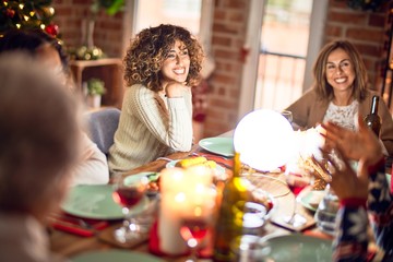Beautiful group of women smiling happy and confident. Eating roasted turkey celebrating christmas at home