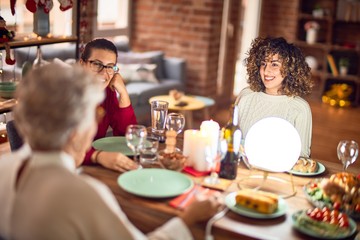 Beautiful group of women smiling happy and confident. Eating roasted turkey celebrating christmas at home