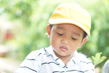 Cute Little Asian kid 18 months or 1.6 year old toddler baby boy child looking at Magnifying glass on the green garden, Save the world and environment Children learning outdoor nature concept.