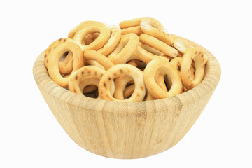 Small dry bagels in bamboo bowl isolated on white background