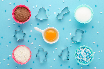 ingredients and cookie cutter on blue background, flat lay