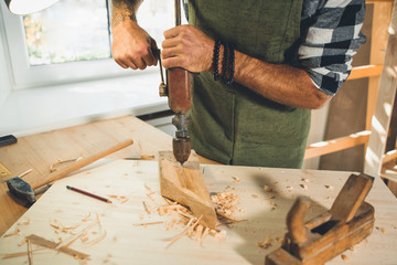 Portrait of a young male carpenter who works in his workshop.