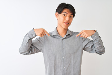 Chinese businessman wearing elegant shirt standing over isolated white background looking confident...