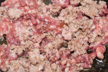 Cooking assorted chicken, pork, veal and turkey minced meat in a pan in sunflower oil and pepper...