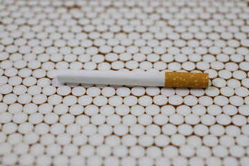 cigarette filters Empty cigarette paper top view Several white cigarettes (tubes) with yellow filters