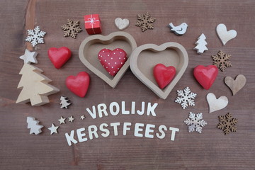 Vrolijk Kerstfeest, Dutch Merry Christmas composed with wooden ornaments over wooden board