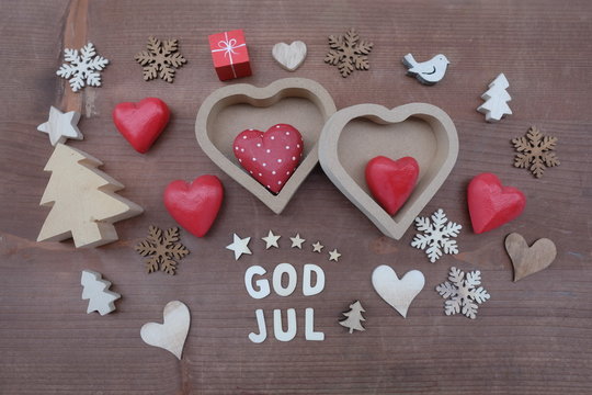 God Jul, swedish and norwegian Merry Christmas text composed with wooden letters and typical ornaments