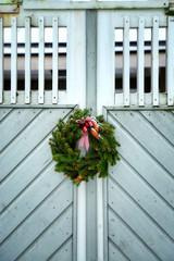 Stylish christmas wreath on a wooden door. Christmas street decor. Houses with christmas decoration. Porvoo oldtown, Finland