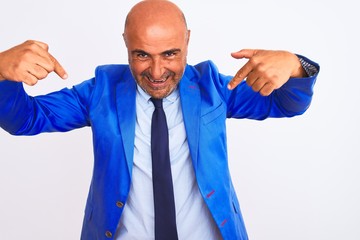 Middle age businessman wearing suit standing over isolated white background looking confident with smile on face, pointing oneself with fingers proud and happy.