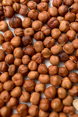 scattered hazelnuts on a light background