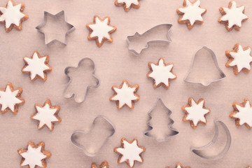 christmas background with cookie cutter and star cookies on baking paper