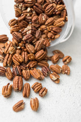 pecans scattered on a light background