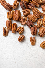 pecans scattered on a light background