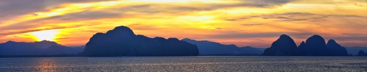 Islands Sunset, Ocean panorama views near Phuket with deep Red, Orange, Purple and Blue, mountains, twilight in Thailand. Including Phi Phi, Ko Rang Yai, Ko Li Pe and other islands. Asia.