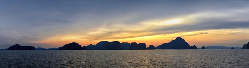 Islands Sunset, Ocean panorama views near Phuket with deep Red, Orange, Purple and Blue, mountains, twilight in Thailand. Including Phi Phi, Ko Rang Yai, Ko Li Pe and other islands. Asia.