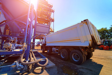 Equipment for production of asphalt, cement and concrete. High tower of an asphalt plant. Harmful...