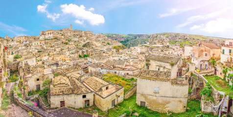 Fototapeta na wymiar Aerial panoramic view of Matera historical city centre Sasso Caveoso, old ancient town Sassi di Matera with rock cave houses buildings, blue sky background, Basilicata, Southern Italy