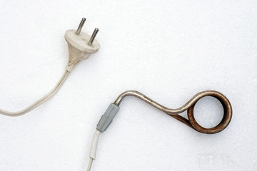 Old rusted immersion heater on a white background. Electrical appliance for heating water. Household boiler. - obrazy, fototapety, plakaty