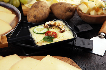 Delicious traditional Swiss melted raclette cheese on diced boiled or baked potato.