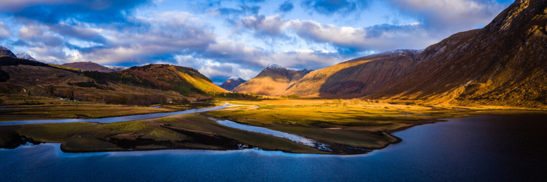 aerial panorama of glen etive and loch etive in the argyll region of the highlands of scotland during autumn and a golden sunset