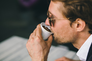 Attractive Bearded Young Guy Is Drinking Coffee Closeup Shot
