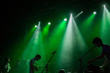  silhouettes of a music group playing live