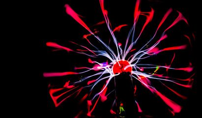 red and blue rays and lightnings on a black background, plasma ball