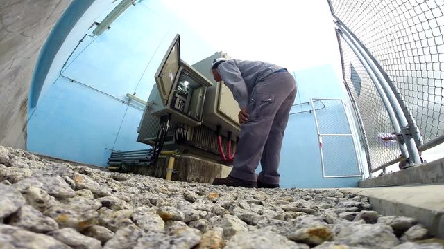 Electricians are checking daily on large transformers.