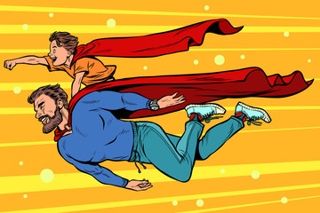dad and son are superheroes. fatherhood and childhood