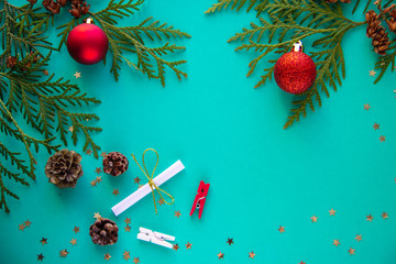 Christmas flatlay with green christmas tree branches and red ball 