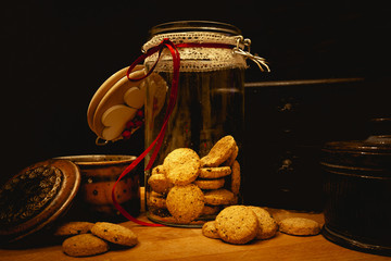 Christmas cookies with festive decoration on a rustic wooden table with colorful bokeh and copy space