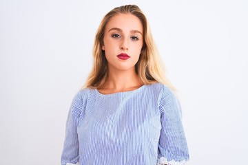 Young beautiful woman wearing elegant blue t-shirt standing over isolated white background with serious expression on face. Simple and natural looking at the camera.