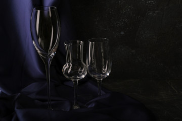 Empty glass wine glass against a dark background under the concrete.