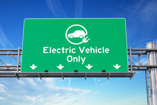 Electric vehicle only green traffic road sign with symbol of electric car on sky background. Ecology and environmental concept background.