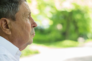 Portrait of a Pensive senior man Outdoors 