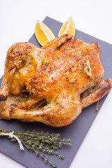 Homemade roasted chicken with lemon on white