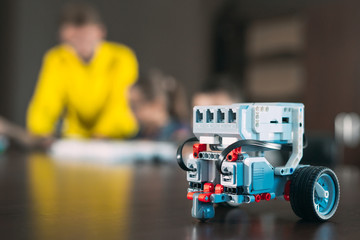 Kids creating robots with teacher. Early development, diy, innovation, modern technology concept. © davit85