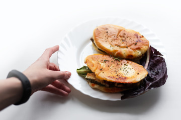 Female hand hold white plate with vegan pitta and radicchio.