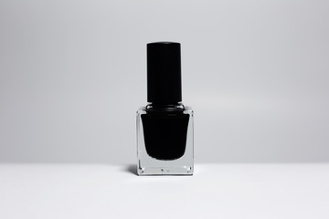 Close-up of black nail polish isolated on white background.