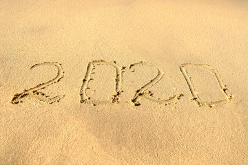 2020 on beach sand. New year 2020 on beach sand. New year concept 