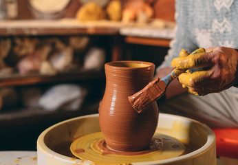 Pottery workshop. A senior man makes a vase of clay. Clay modeling