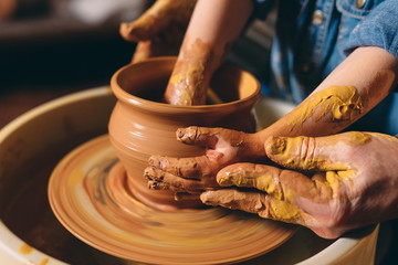 Pottery workshop. Grandpa teaches granddaughter pottery. Clay modeling