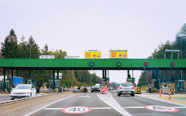 Cars at Toll booth on the road in Slovenia. Highway toll. Speed limit 40 kilimetres per hour.