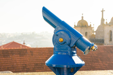 sightseeing coin operated binocular. touristic viewfinder or telescope  against city panoramic view of porto, portugal.