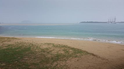 St. John Island beach in Singapore on a super rainy day overlooking a colonial era ship